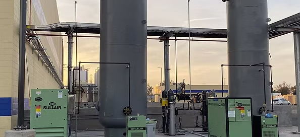 sullair air compressors outside in front of air tanks