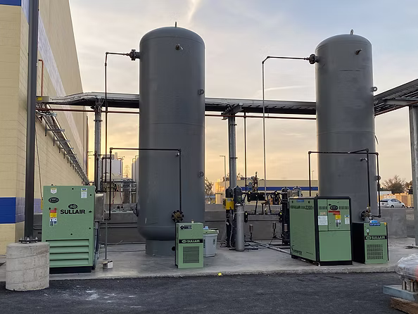 sullair air compressors outside in front of air tanks